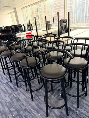 Set of sturdy black metal bar stools with cushioned seats - multiple available