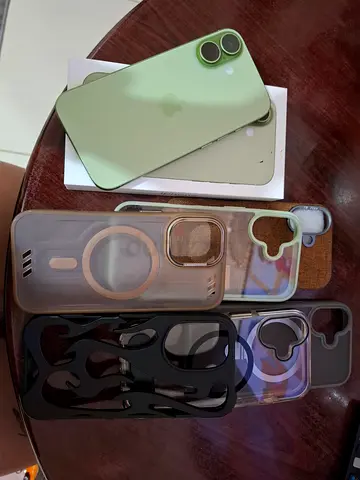 iPhone 17 in green with multiple protective cases (used but not abused)