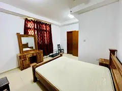 Fully furnished master bedroom with attached bath and balcony for family