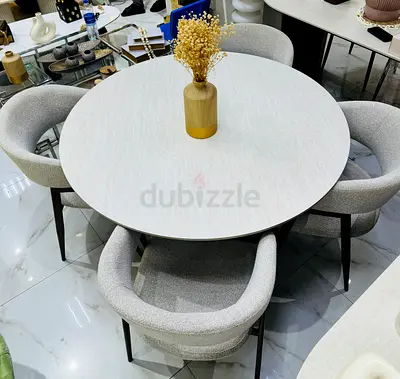 Round dining table with 4 upholstered chairs