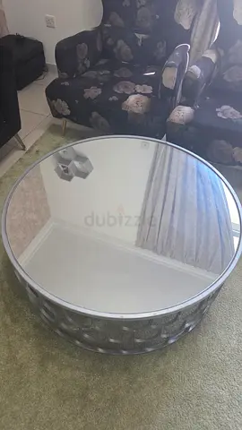 Modern Round Mirrored Coffee Table with Silver Metal Base. Dimensions, L&W = 100cm and H=40cm