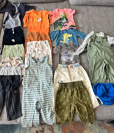 Lot of mixed baby clothes — rompers, pants, tops (size 0-12 months)