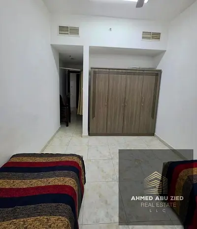 A spacious four-bedroom apartment with a hall is available for annual rent in Emirates City, Ajman. The apartment includes 3 bathrooms and parking an