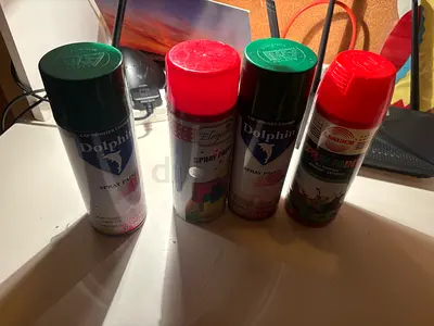 Set of 4 spray paint cans — various colors, lightly used