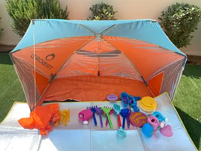 Beach sun shelter with kids sand toys - used