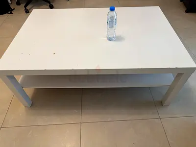 White rectangular coffee table Ikea with lower shelf, used