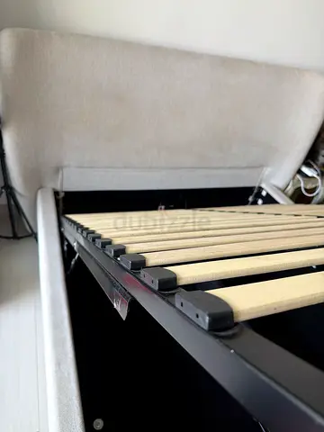 Urgent sale Queen size bed frame with wooden slats and upholstered base good condition home center