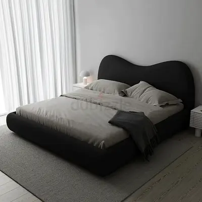 Modern upholstered double bed with curved headboard