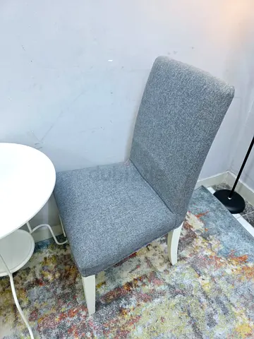 Grey upholstered dining chair with white legs - single piece