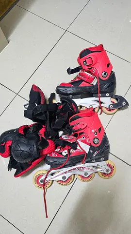 Red and black inline roller skates — used