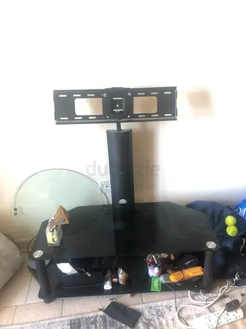 Black glass TV stand with mount and shelving - good condition