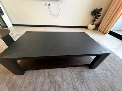 Solid dark wood coffee table with lower shelf — good condition