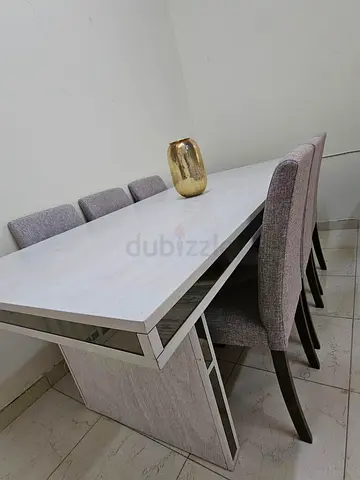Modern white dining table with 6 upholstered chairs