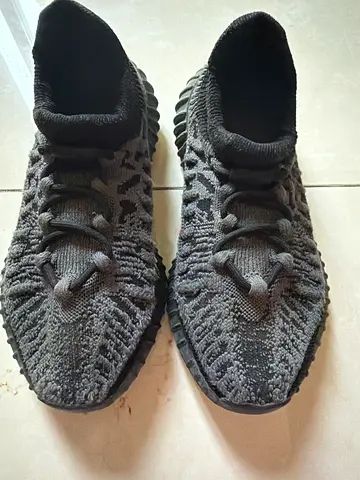 Used pair of black knit casual sneakers, size not specified