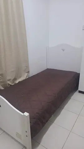 Single white wooden bed frame with headboard and footboard
