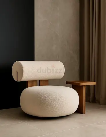 Modern cream boucle lounge chair with built-in wooden side table