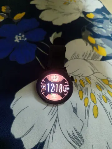 Black round smartwatch with silicone strap - working condition