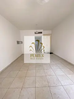 Studio for annual rent in Al Rashidiya 3, featuring a separate kitchen; located next to Grand Mall a