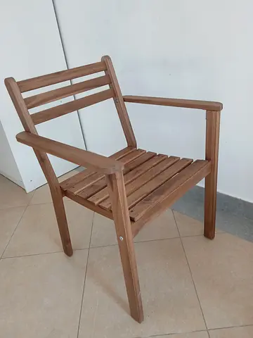 Solid wooden armchair — natural finish, good condition