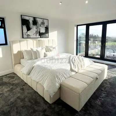 Modern upholstered king-size bed with padded headboard