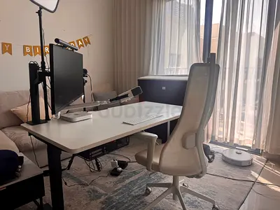White sit-stand office desk with ergonomic + white mesh office chair