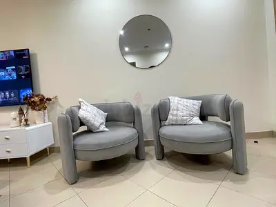 Pair of modern grey upholstered round lounge chairs - excellent condition