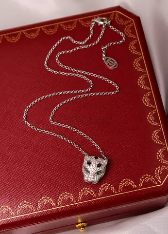 Silver panther head pendant necklace with green stone eyes