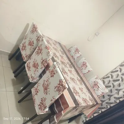 6-seater dining table with floral chairs and it's cover