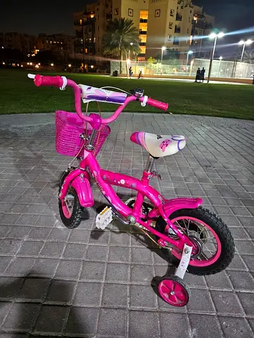Pink kids' 12-inch bicycle with training wheels and basket