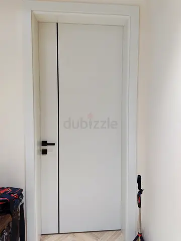 Modern white interior door WPC with black handle - good condition