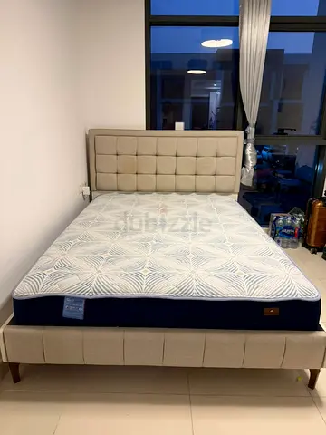 Queen upholstered bed frame with mattress - beige, good condition, good as new.