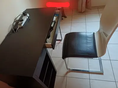 Compact black study desk with storage cubbies and chair