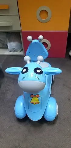 Blue ride-on toy pony with music and lights - good condition