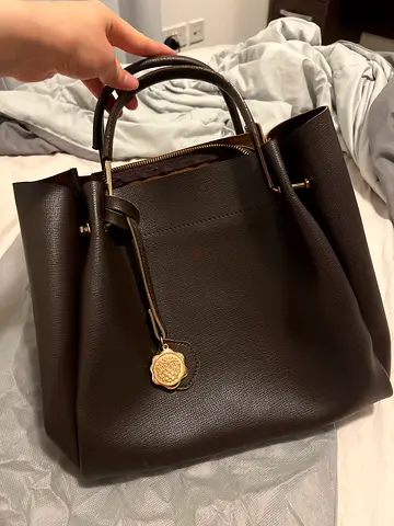 Dark brown leather tote handbag with gold emblem - great condition