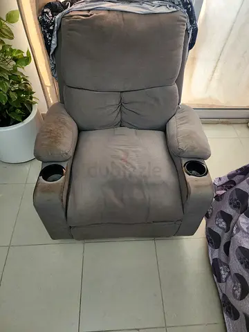 Comfortable grey recliner armchair with cup holders
