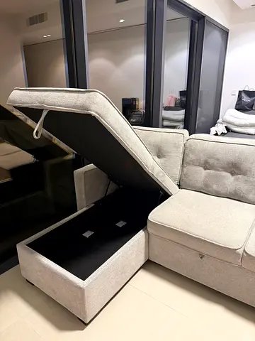 Light grey L-shaped storage sofa with removable cushions - good condition