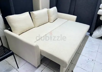 Cream convertible sofa bed - compact 2-seater with cushions
