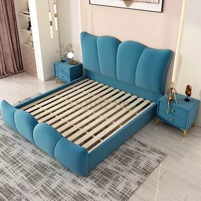 Blue upholstered queen bed frame with curved headboard and footboard