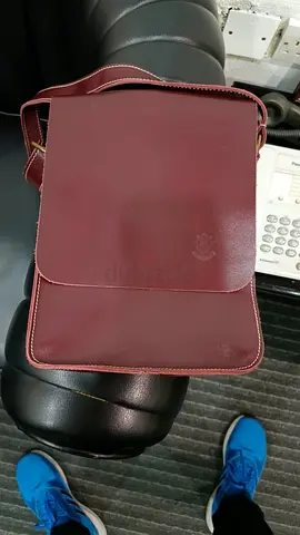 Genuine leather maroon coloured sling bag