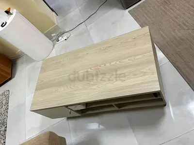 Light wood coffee table with storage shelves - good condition