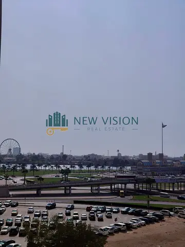 Two-bedroom apartment with an open view, large balcony, and free parking. Prime location near the Dubai Exit. Security deposit by non-cashable cheque,
