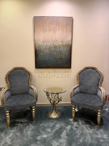 Decorative Tree-Branch Side Table with Glass Top and accent chairs and painting