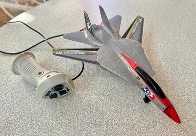 An old model of remote control fighter jet toy with wired controller - working condition