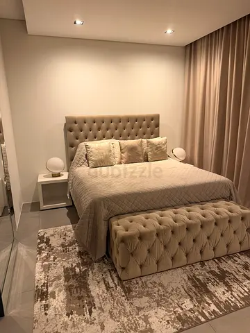 Queen tufted bed frame with mattress and bedside tables lamps and rug - good condition