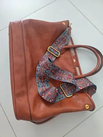 Brown leather tote bag with patterned detachable shoulder strap