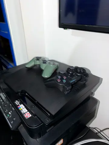 Sony PlayStation 3 Slim console with 2 contortions, the black controller is brand new