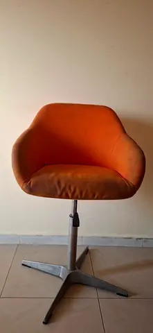 Orange swivel lounge chair with metal base - good used condition