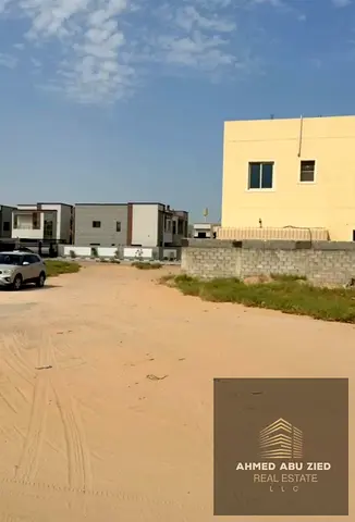 Residential Corner Plot on Street & Sikka in Al Helio 2, Ajman | 3,014 Sq. Ft. | G+1 Villa Permit | Near Main Road | AED 570K