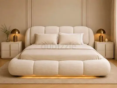 Modern upholstered king bed with curved padded headboard — beige