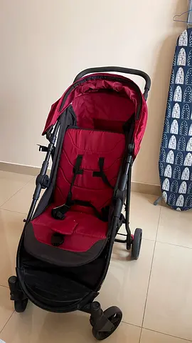 Lightweight red baby stroller in good condition